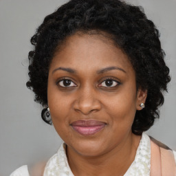 Joyful black adult female with medium  brown hair and brown eyes