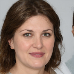 Joyful white adult female with medium  brown hair and brown eyes