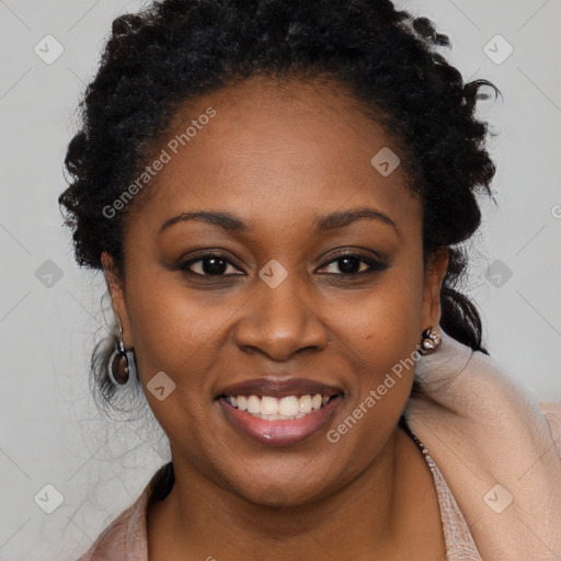 Joyful black young-adult female with long  brown hair and brown eyes