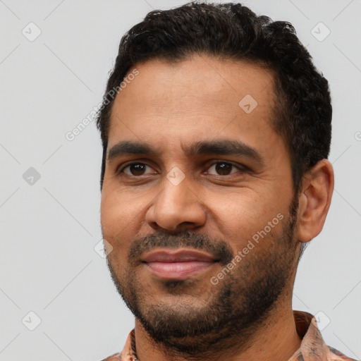 Joyful black young-adult male with short  black hair and brown eyes