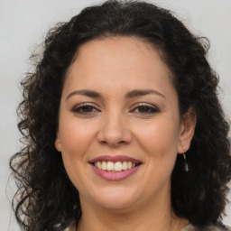 Joyful white adult female with long  brown hair and brown eyes