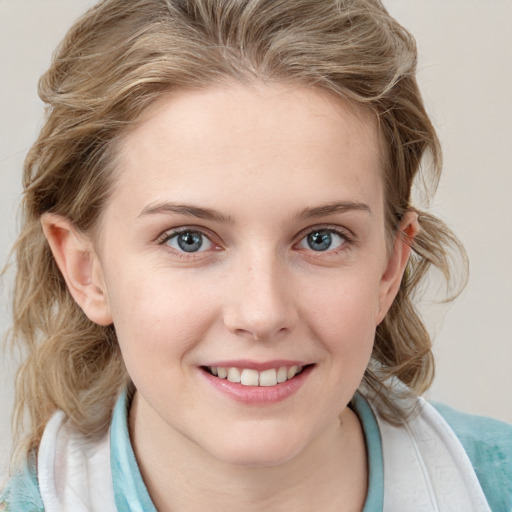 Joyful white young-adult female with medium  brown hair and blue eyes