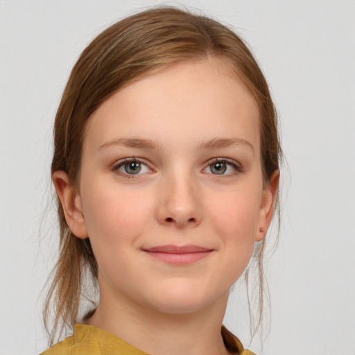 Joyful white child female with medium  brown hair and grey eyes