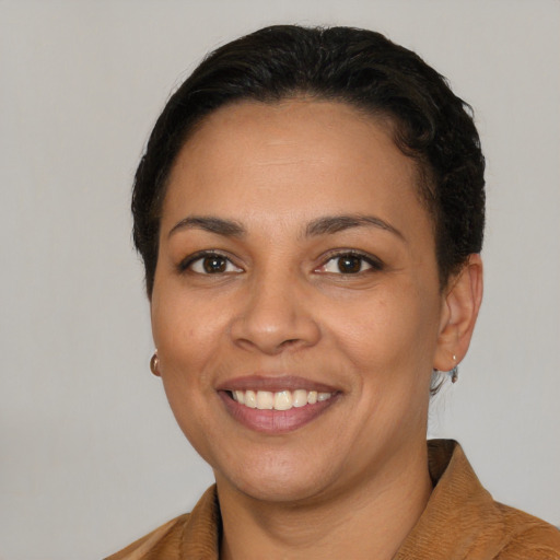 Joyful latino young-adult female with short  brown hair and brown eyes