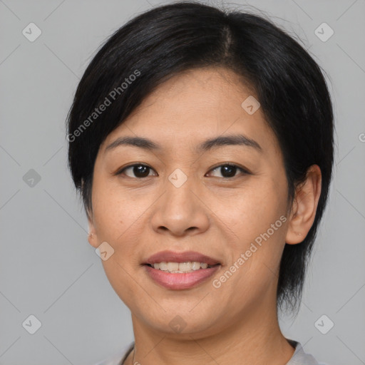 Joyful asian adult female with medium  brown hair and brown eyes