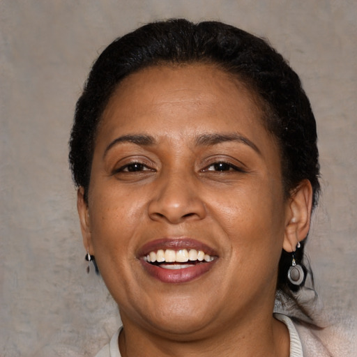 Joyful latino adult female with short  brown hair and brown eyes