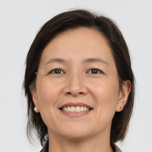 Joyful white adult female with medium  brown hair and brown eyes