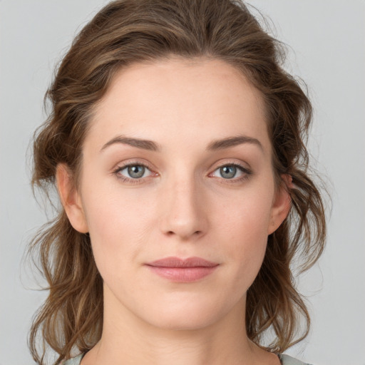 Joyful white young-adult female with medium  brown hair and green eyes