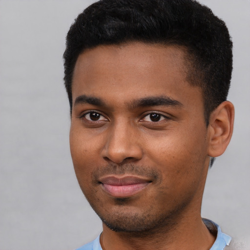 Joyful black young-adult male with short  black hair and brown eyes