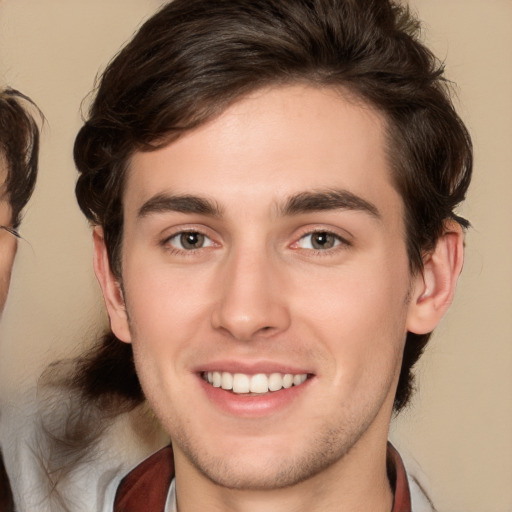 Joyful white young-adult male with medium  brown hair and brown eyes