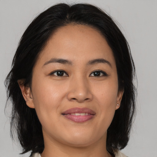 Joyful asian young-adult female with medium  brown hair and brown eyes