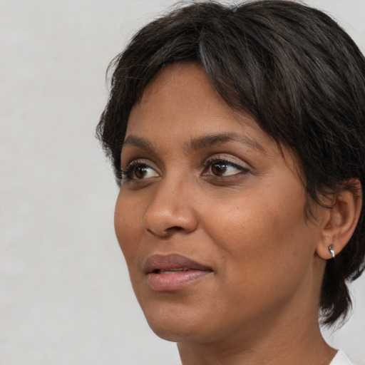 Neutral black adult female with medium  brown hair and brown eyes