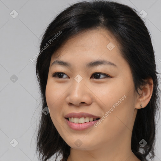 Joyful asian young-adult female with long  brown hair and brown eyes