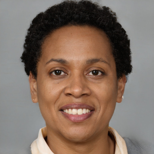 Joyful black young-adult female with short  brown hair and brown eyes