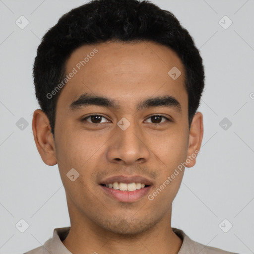 Joyful asian young-adult male with short  black hair and brown eyes