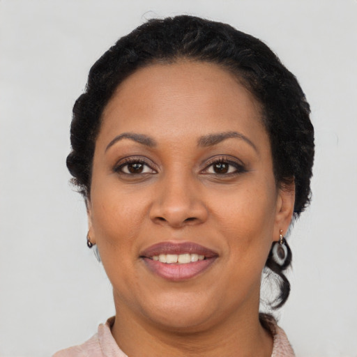 Joyful latino adult female with short  brown hair and brown eyes