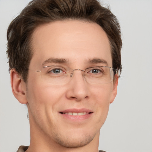 Joyful white adult male with short  brown hair and grey eyes