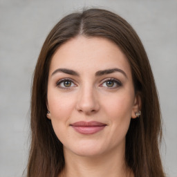 Joyful white young-adult female with long  brown hair and green eyes