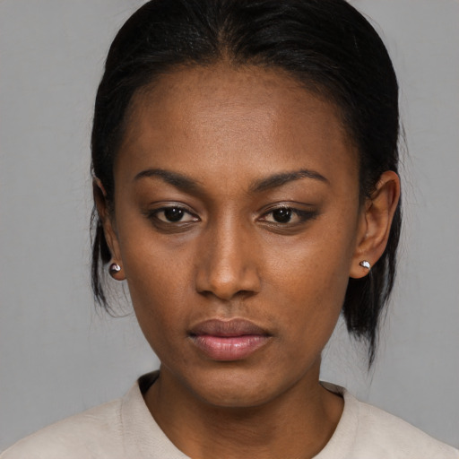 Neutral black young-adult female with medium  brown hair and brown eyes