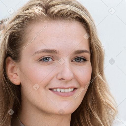 Joyful white young-adult female with long  brown hair and blue eyes