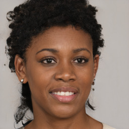 Joyful black young-adult female with short  brown hair and brown eyes