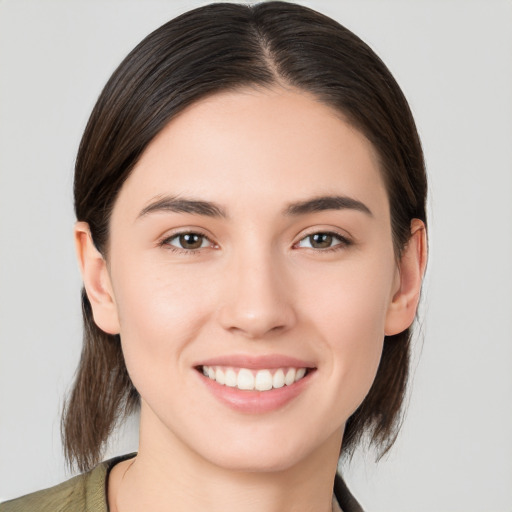 Joyful white young-adult female with medium  brown hair and brown eyes