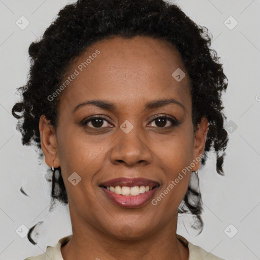 Joyful black adult female with medium  brown hair and brown eyes