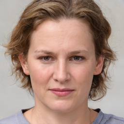 Joyful white young-adult female with medium  brown hair and blue eyes