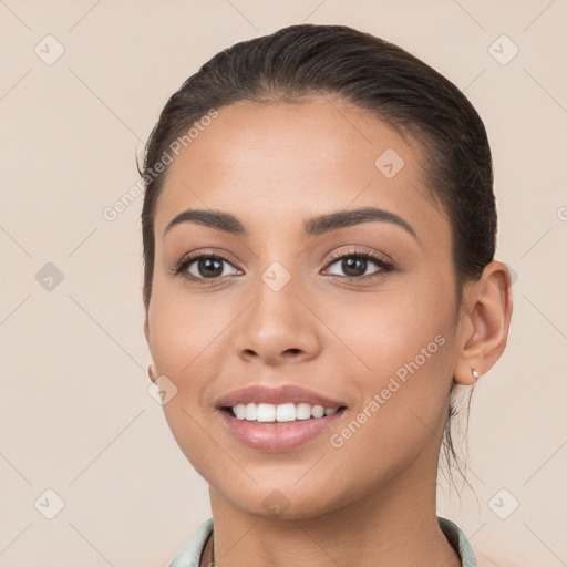 Joyful white young-adult female with long  brown hair and brown eyes