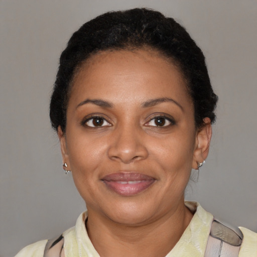 Joyful black adult female with short  black hair and brown eyes