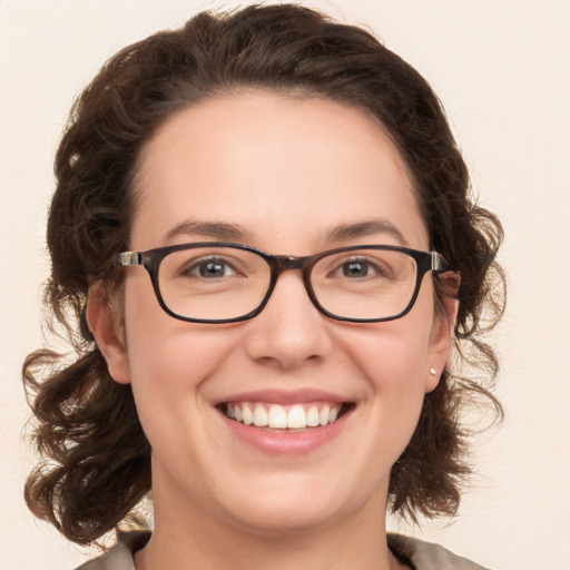 Joyful white young-adult female with medium  brown hair and green eyes