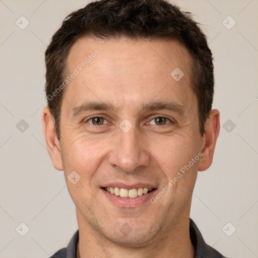 Joyful white adult male with short  brown hair and brown eyes