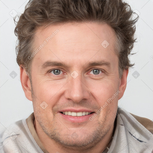 Joyful white adult male with short  brown hair and grey eyes