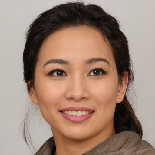 Joyful white young-adult female with medium  brown hair and brown eyes