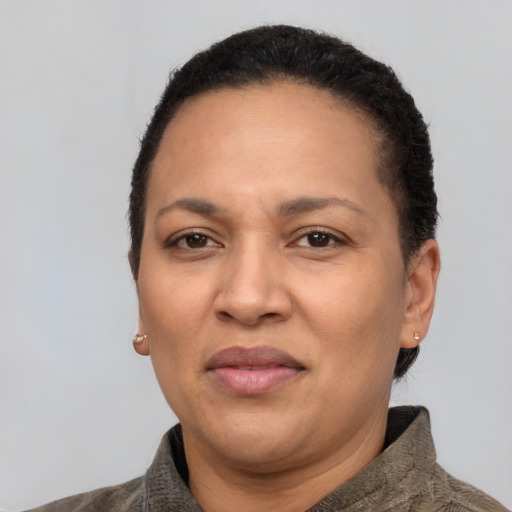 Joyful latino adult female with short  brown hair and brown eyes