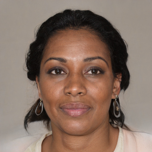 Joyful black adult female with medium  black hair and brown eyes