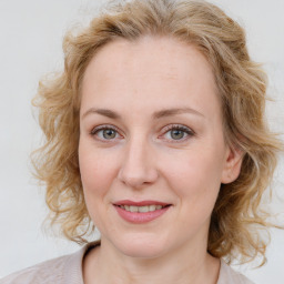 Joyful white young-adult female with medium  brown hair and blue eyes