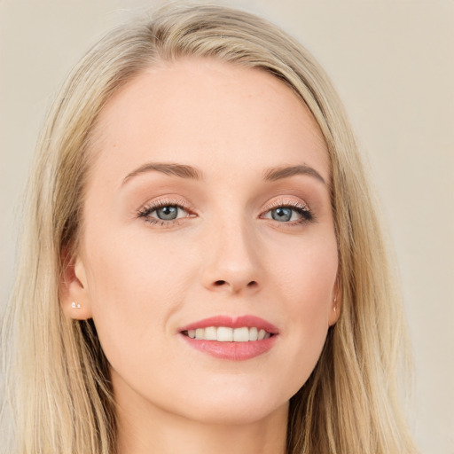 Joyful white young-adult female with long  brown hair and blue eyes