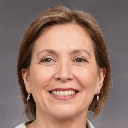 Joyful white adult female with medium  brown hair and grey eyes