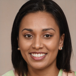 Joyful latino young-adult female with medium  brown hair and brown eyes