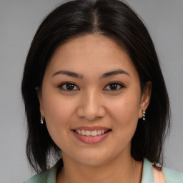 Joyful asian young-adult female with medium  brown hair and brown eyes