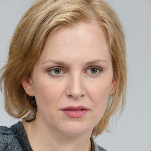 Joyful white young-adult female with medium  brown hair and blue eyes