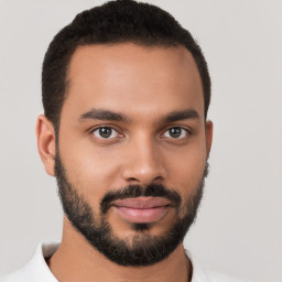 Joyful latino young-adult male with short  brown hair and brown eyes