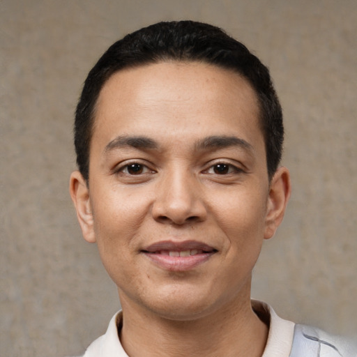 Joyful latino young-adult male with short  black hair and brown eyes