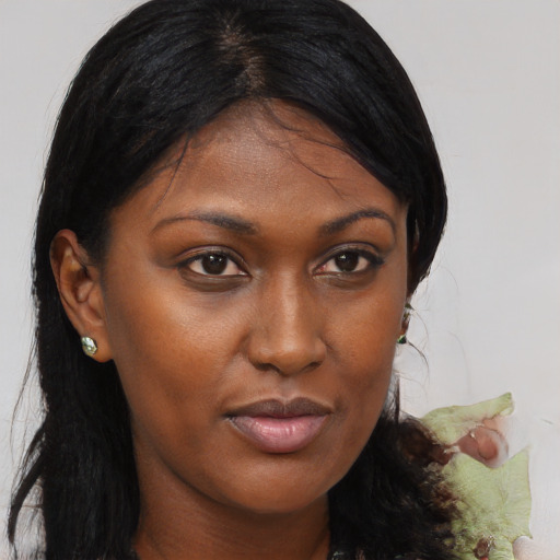 Joyful black young-adult female with medium  brown hair and brown eyes