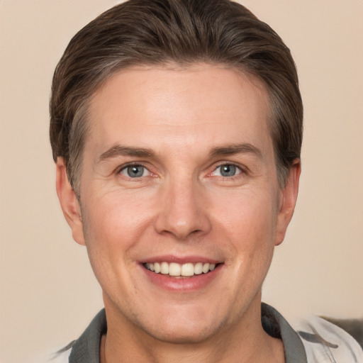 Joyful white adult male with short  brown hair and grey eyes