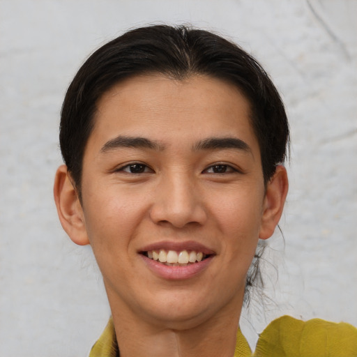Joyful latino young-adult male with short  brown hair and brown eyes