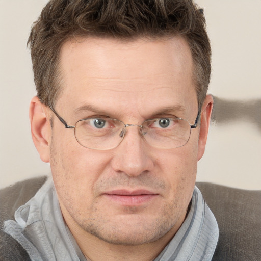 Joyful white adult male with short  brown hair and grey eyes