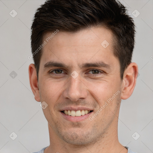 Joyful white young-adult male with short  brown hair and brown eyes