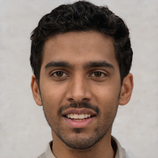Joyful white young-adult male with short  black hair and brown eyes